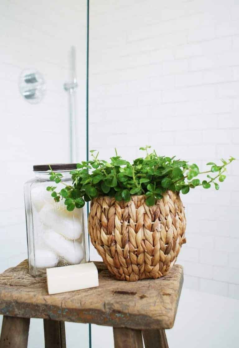 love this white rustic metro tiles shower with patterned floor tiles and vintage milking stool with vintage soap jar and reclaimed wood stool. Click through for eco bathrrom ideas for plastic free and zero waste beauty you'll love