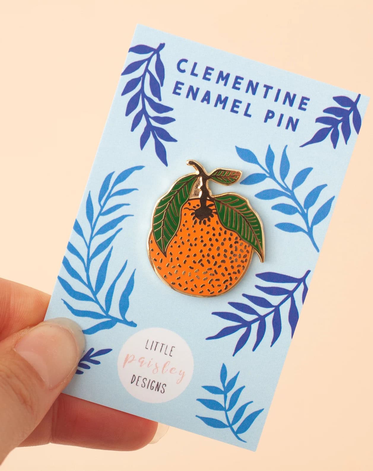 handmade enamel pin by paisley designs from etsy in a lovely clementine design