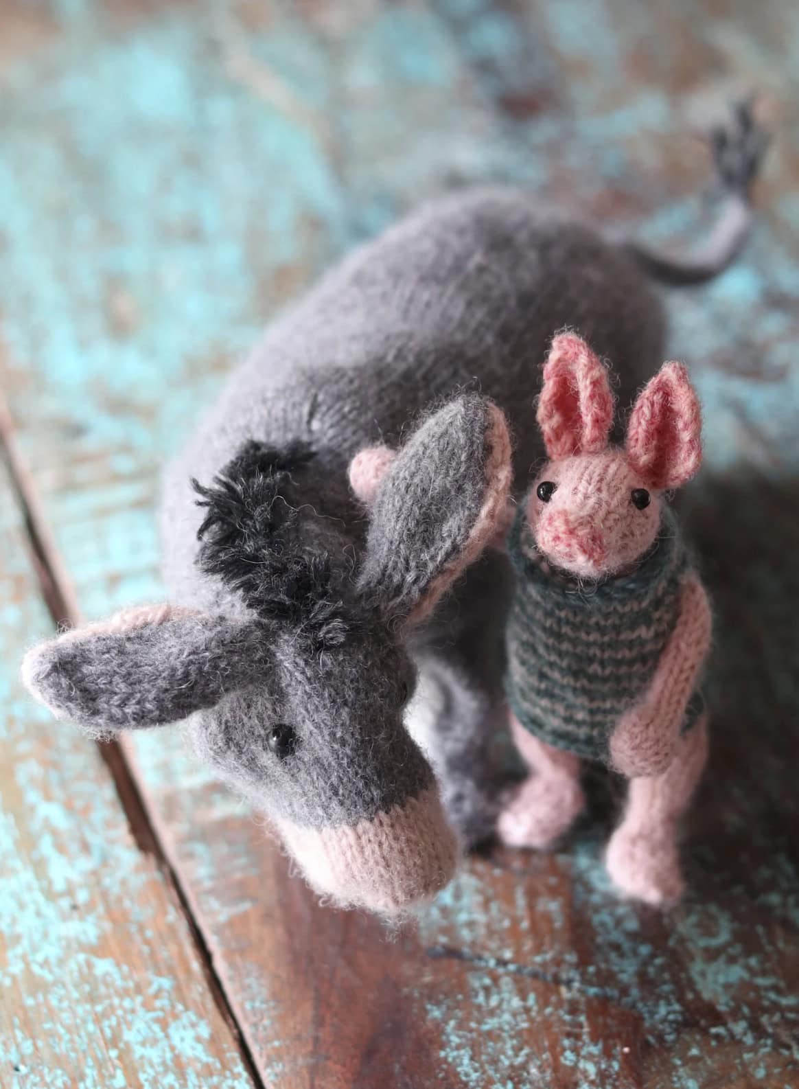 Piglet and Eeyore knitting patterns by Claire Garland aka Dot Pebbles Knits - part of her Winnie the Pooh collection that includes Eeyore and Honey Bear inspired by Pooh Bear. All lovable and easy to knit. Click through to get your PDF download pattern today and start knitting!